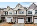 Inviting townhome exteriors with stone accents, garages and landscaped front yards at 5 Galway Glenn Ln, Durham, NC 27705
