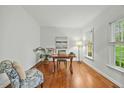 Home office featuring hardwood floors, neutral walls, and bright window with natural outdoor light at 5109 Windance Pl, Holly Springs, NC 27540