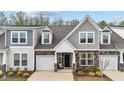 Attractive townhome showcasing stone accents, neutral siding, and a welcoming front entrance at 53 Whitley Ridge Dr, Clayton, NC 27527