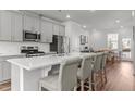 Spacious kitchen featuring stainless steel appliances and a large quartz island at 5432 Crescent Square St, Raleigh, NC 27616