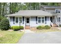 Charming home featuring blue siding, black shutters, lovely lawn and paved drive at 6417 Meadow View Dr, Raleigh, NC 27609