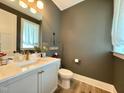Charming powder room featuring neutral colors and lovely decorative accents at 6521 Camellia Creek Dr, Raleigh, NC 27603
