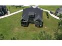Aerial view of home's rear featuring a screened porch, and expansive lawn at 6521 Camellia Creek Dr, Raleigh, NC 27603
