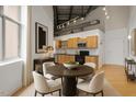 Bright kitchen with stainless appliances, wood cabinets and dining table for an eat-in space at 700 Market St # 214, Chapel Hill, NC 27516