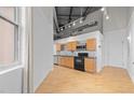 Modern kitchen with wood cabinets and hardwood floors at 700 Market St # 214, Chapel Hill, NC 27516