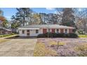 Classic brick home featuring a well-kept lawn and inviting curb appeal at 706 Forest Dr, Garner, NC 27529