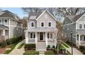Charming two-story home featuring a covered front porch with white columns and manicured landscaping at 711 Virginia Ave, Raleigh, NC 27604