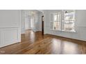 Bright living room with hardwood floors, large windows, and elegant finishes at 711 Virginia Ave, Raleigh, NC 27604