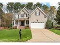 Beautiful exterior view of a two-story home featuring a well-kept lawn and a spacious driveway leading to the garage at 7252 Bedford Ridge Dr, Apex, NC 27539