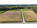 Expansive aerial view of a property with a house, outbuildings, and a long driveway on a large lot at 8079 Stone Heritage Rd, Middlesex, NC 27557