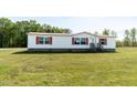 A well-maintained single story home with a charming red roof and white siding with front yard at 8091 Stone Heritage Rd, Middlesex, NC 27557