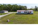 A charming home featuring a red roof and shutters nestled in a green, grassy lot at 8091 Stone Heritage Rd, Middlesex, NC 27557
