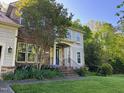 Charming home with stone and shingle siding, a well-manicured lawn, and colorful landscaping at 8300 Clarks Branch Dr, Raleigh, NC 27613