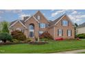Lovely brick home features lush landscaping, a manicured lawn and a tranquil fountain at 9201 Club Hill Dr, Raleigh, NC 27617