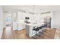 Modern kitchen featuring stainless steel appliances and a spacious island with seating at 1003 Canary Pepper Dr, Durham, NC 27713