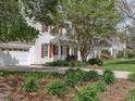 Well-maintained home with two-car garage, beautiful landscaping, and a charming front porch area at 1008 Brittley Way, Apex, NC 27502