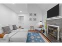 Cozy living room featuring a fireplace, hardwood floors, and a comfortable gray sofa at 102 Choptank Ct # B5, Cary, NC 27513