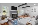 Open concept living room with a fireplace, dining area, and hardwood floors at 102 Choptank Ct # B5, Cary, NC 27513