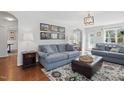 Cozy living room featuring comfortable seating, decorative rug, and ample natural light at 1039 S Philwood Ct, Fuquay Varina, NC 27526
