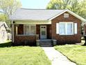 Charming brick home featuring a classic design, well-maintained lawn, and welcoming front entrance at 111 113 Highland Ave, Burlington, NC 27217
