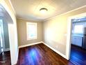 Bright room featuring freshly painted walls, wood floors and bright natural light from the window at 111 113 Highland Ave, Burlington, NC 27217