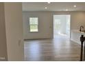 Bright living room showcasing hardwood floors and expansive windows, offering a light-filled and inviting space at 1140 Sun Springs Rd, Wake Forest, NC 27587