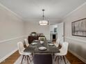 Elegant dining room with modern chandelier, stylish decor, and wood floors, great for entertaining guests at 122 Monticello Ave, Durham, NC 27707