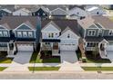 Aerial shot of a light blue two-story home in a suburban neighborhood with well-kept lawns at 1237 Porters Call Dr, Wendell, NC 27591