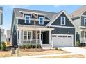 Charming two-story home with a well-manicured lawn and inviting front porch and a two car garage at 1237 Porters Call Dr, Wendell, NC 27591
