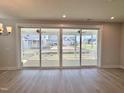 Bright living room with wood-look floors and sliding glass doors to the screened in porch at 1237 Porters Call Dr, Wendell, NC 27591