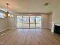 Bright living room with wood-look floors, a fireplace, recessed lighting and sliding glass doors to the porch at 1237 Porters Call Dr, Wendell, NC 27591
