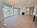 Bright living room featuring a fireplace, wood floors and large sliding glass doors to the backyard at 1237 Porters Call Dr, Wendell, NC 27591
