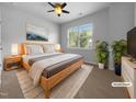 Comfortable bedroom with a large bed, soft rug, large window, and stylish decor for relaxation at 1412 Wesser Ct, Fuquay Varina, NC 27526