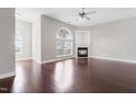 Bright living room with hardwood floors, arched window, and cozy fireplace at 2101 Piney Brook Rd # 105, Raleigh, NC 27614