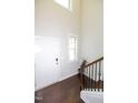 Entryway featuring hardwood floors and stairs with a window and door to the right at 2123 Gregor Overlook Ln, Apex, NC 27502