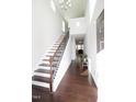 Bright entryway with hardwood floors, staircase, and a view into the living area at 2123 Gregor Overlook Ln, Apex, NC 27502