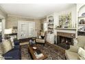 Inviting living room with a brick fireplace, built-in shelving, and hardwood floors at 228 Old Colony Way, Rocky Mount, NC 27804