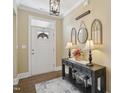 Welcoming entryway featuring a console table, decorative mirrors, and stylish lamps at 2308 Swansea Ln, Apex, NC 27502