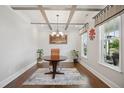 Elegant home office with coffered ceilings, a round table, and natural light from large windows at 2308 Swansea Ln, Apex, NC 27502