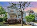 Charming two-story home featuring a welcoming porch, landscaped yard and attached garage at 3047 Kilarney Ridge Loop, Cary, NC 27511