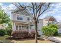 Charming two-story home featuring a welcoming porch, landscaped yard and attached garage at 3047 Kilarney Ridge Loop, Cary, NC 27511