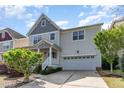 Charming two-story home featuring a welcoming porch, landscaped yard and attached garage at 3047 Kilarney Ridge Loop, Cary, NC 27511