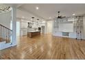 Spacious living room with hardwood floors, a built-in entertainment center, stairs and an eat-in kitchen at 35 Big Bear Dr, Pittsboro, NC 27312