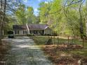 Ranch home with a gravel driveway, stone accents, and a well maintained lawn at 359 Punch Hill Farm Rd, Rougemont, NC 27572