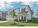 Well-manicured front yard and a two-story home with an attached two car garage at 3841 Rosebush Dr, Zebulon, NC 27597
