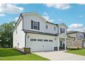 Two-story home showing the side and front exterior with a two car garage and nicely manicured lawn at 3841 Rosebush Dr, Zebulon, NC 27597