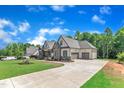 A home showcasing the long driveway and ample parking space in front of an attached garage at 3920 Cedar Knolls Drive Dr # 18, Youngsville, NC 27596