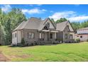 Front yard view of a traditional brick home with manicured lawn and detailed architectural features at 3920 Cedar Knolls Drive Dr # 18, Youngsville, NC 27596