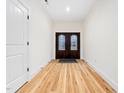 Bright entryway with light wood floors and decorative double doors at 42 Ponchartrain St, Fuquay Varina, NC 27526