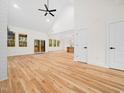 Spacious living room with high ceilings, modern ceiling fan, and large windows showcasing natural light at 42 Ponchartrain St, Fuquay Varina, NC 27526